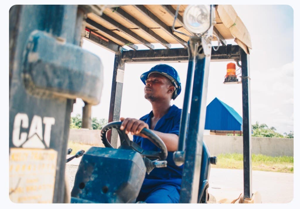Operator driving a CAT forklift on site
